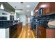 Long kitchen with modern appliances, dark countertops, wood cabinets, and open layout at 44 Peachtree Nw Pl # 629, Atlanta, GA 30309