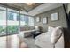 Sunny living room with large windows, city views, and modern decor for comfortable living at 44 Peachtree Nw Pl # 629, Atlanta, GA 30309