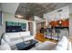Bright living room with modern furnishings, open floor plan, and exposed concrete ceiling at 44 Peachtree Nw Pl # 629, Atlanta, GA 30309