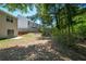 This backyard has a bit of an incline, a line of trees, and a concrete patio pad at 5660 Sable Bay Pt, Atlanta, GA 30349