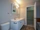 Bathroom featuring double sink vanity, tile flooring and an adjoining room at 5660 Sable Bay Pt, Atlanta, GA 30349