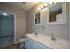 Bathroom with double sink vanity, framed mirrors and a walk-in closet at 5660 Sable Bay Pt, Atlanta, GA 30349