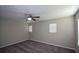 Bedroom features neutral paint, plush carpet, a ceiling fan and natural light at 5660 Sable Bay Pt, Atlanta, GA 30349