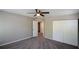 This bedroom has soft carpet, a ceiling fan, and a double door closet for lots of storage space at 5660 Sable Bay Pt, Atlanta, GA 30349