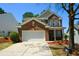 Inviting two-story brick home with a two-car garage and manicured landscaping at 5660 Sable Bay Pt, Atlanta, GA 30349