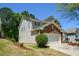 View of home showing siding, brick accents, yard and 2-car garage at 5660 Sable Bay Pt, Atlanta, GA 30349
