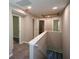 Hallway with carpet flooring featuring multiple doors leading to other rooms at 5660 Sable Bay Pt, Atlanta, GA 30349