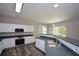 This bright and modern kitchen boasts an efficient layout, modern appliances, and plentiful white cabinetry at 5660 Sable Bay Pt, Atlanta, GA 30349