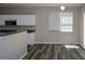 Bright kitchen features white cabinets, a breakfast bar, and stainless steel appliances with a chandelier at 5660 Sable Bay Pt, Atlanta, GA 30349