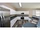 This kitchen offers modern appliances, ample counter space, and plenty of white cabinet storage at 5660 Sable Bay Pt, Atlanta, GA 30349