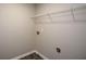 Laundry room features a wire shelf, neutral paint, and vinyl flooring at 5660 Sable Bay Pt, Atlanta, GA 30349