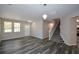 Spacious living room with wood-look floors, stairs, and lots of natural light at 5660 Sable Bay Pt, Atlanta, GA 30349