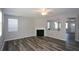 Cozy living room featuring a fireplace, large windows, and an open floor plan at 5660 Sable Bay Pt, Atlanta, GA 30349