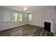 Bright living room with large windows, a ceiling fan, and a fireplace offers plenty of natural light at 5660 Sable Bay Pt, Atlanta, GA 30349