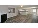 Open-concept living room boasts wood floors, a fireplace, and connects to a kitchen with an island at 5660 Sable Bay Pt, Atlanta, GA 30349