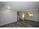 Open-concept living room with view of staircase and adjacent rooms featuring wood-look floors at 5660 Sable Bay Pt, Atlanta, GA 30349
