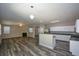 Open floor plan features a fireplace, ceiling fan, and modern kitchen at 5660 Sable Bay Pt, Atlanta, GA 30349