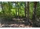 Beautiful wooded property with mature trees offers privacy and natural beauty at 5660 Sable Bay Pt, Atlanta, GA 30349