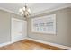 Bedroom featuring beautiful hardwood floors, a window, and closet with classic chandelier at 638 Cooledge Ne Ave, Atlanta, GA 30306