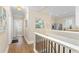 Hallway with hardwood floors leading to a kitchen with stainless appliances and a tiled backsplash at 638 Cooledge Ne Ave, Atlanta, GA 30306