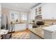 Bright kitchen featuring stainless steel appliances, granite countertops, white cabinetry, and natural light at 638 Cooledge Ne Ave, Atlanta, GA 30306