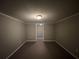 Unfinished basement space with neutral paint and an open doorway at 120 Grove Ln, Temple, GA 30179