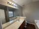 Bathroom featuring a large mirror and vanity with combination tub/shower and separate soaking tub at 120 Grove Ln, Temple, GA 30179