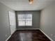 This bedroom features a window with natural light and wood-look floors at 120 Grove Ln, Temple, GA 30179
