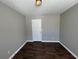 Neutral bedroom with wood-look flooring, a ceiling light and natural light at 120 Grove Ln, Temple, GA 30179