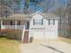Charming home with a two-car garage, front porch, and mature landscaping at 120 Grove Ln, Temple, GA 30179
