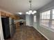 Eat-in kitchen featuring stainless steel appliances, ample cabinets, and tile floors at 120 Grove Ln, Temple, GA 30179