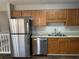 Kitchen featuring stainless steel appliances, wood cabinets and tile floors at 120 Grove Ln, Temple, GA 30179