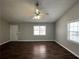 Bright living room featuring a ceiling fan, hardwood floors and natural light at 120 Grove Ln, Temple, GA 30179
