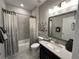 Stylish bathroom with a single sink vanity, shower-tub combo and modern finishes at 2702 Wollerton St # 2702, Cumming, GA 30040