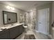 Modern bathroom with marble floors, gray vanity, and shower-tub combo at 2702 Wollerton St # 2702, Cumming, GA 30040