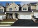 Charming townhome showcasing well-manicured landscaping, attached garage, and inviting entrance at 2702 Wollerton St # 2702, Cumming, GA 30040