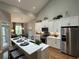 Modern kitchen with stainless steel appliances, island with seating, and ample cabinet space at 2702 Wollerton St # 2702, Cumming, GA 30040