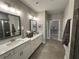 Elegant main bathroom featuring double vanity sinks, modern fixtures, and walk-in closet at 2702 Wollerton St # 2702, Cumming, GA 30040