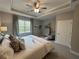Serene main bedroom with tray ceiling, neutral colors, and large window at 2702 Wollerton St # 2702, Cumming, GA 30040
