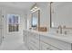 Bright bathroom with double vanity, marble floors, a soaking tub, and a glass shower, creates a relaxing retreat at 345 Sugarview Rd, Sugar Hill, GA 30518