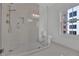 Bright bathroom featuring a glass shower, modern fixtures, and a view to the outside at 345 Sugarview Rd, Sugar Hill, GA 30518