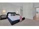 Stylish bedroom featuring plush bedding, modern bedside tables, and a view into the hallway at 345 Sugarview Rd, Sugar Hill, GA 30518