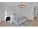 Bright bedroom with wooden floor, large rug, board and batten accent wall, and modern light fixture at 345 Sugarview Rd, Sugar Hill, GA 30518