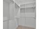 A well-organized, walk-in closet featuring multiple shelves and hanging racks for ample storage at 345 Sugarview Rd, Sugar Hill, GA 30518