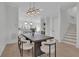 Dining room with modern chandelier, table, and stairs at 345 Sugarview Rd, Sugar Hill, GA 30518