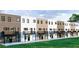 Rear view of townhouses with private balconies, brick accents, and well-maintained green space at 345 Sugarview Rd, Sugar Hill, GA 30518