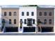 Elegant townhouses with mixed brick exteriors, large windows, private balconies, and integrated garage spaces at 345 Sugarview Rd, Sugar Hill, GA 30518