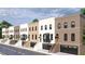 Charming row of townhouses featuring brick facades, black framed windows, and convenient garage access at 345 Sugarview Rd, Sugar Hill, GA 30518
