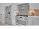 Modern kitchen with stainless steel appliances and subway tile backsplash at 345 Sugarview Rd, Sugar Hill, GA 30518