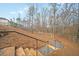 Gravel path leading through the yard with stone steps and metal handrails on a sunny day at 2020 Rivermont Way, Roswell, GA 30076